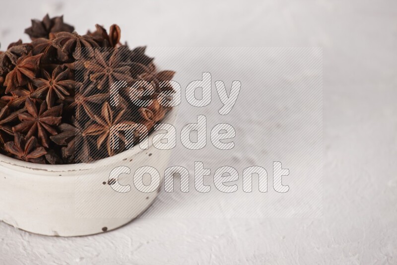 Star Anise in a white bowl on white background