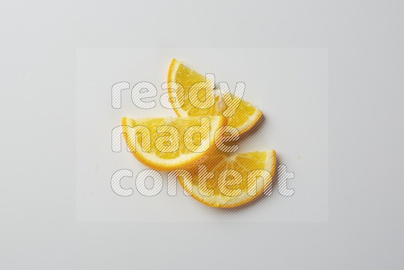 Three halves of an orange slices on white background