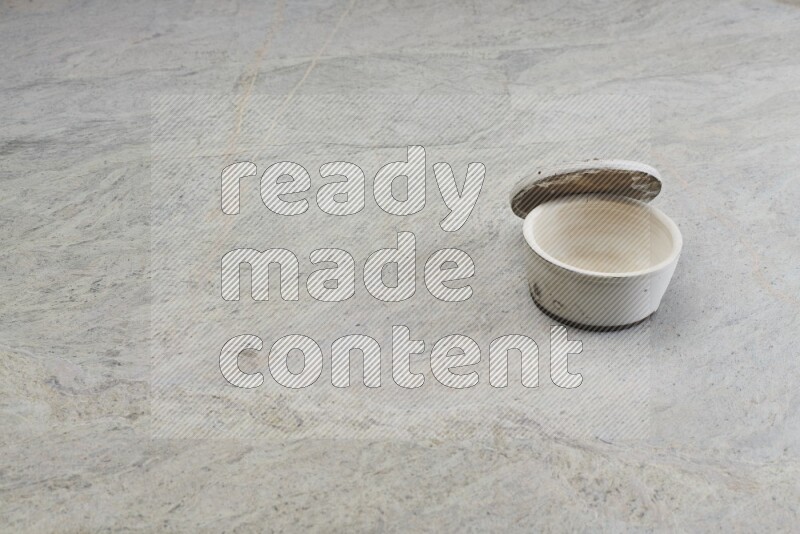 A white pottery bowl on grey marble background