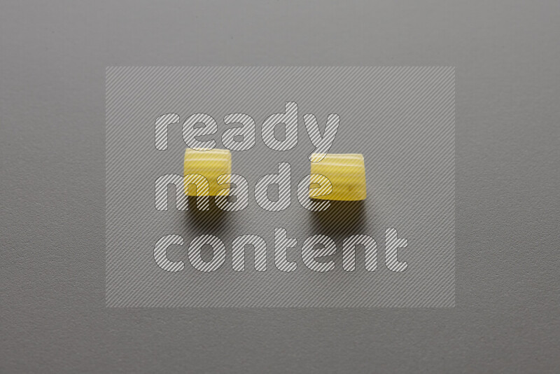 Small rings pasta on grey background