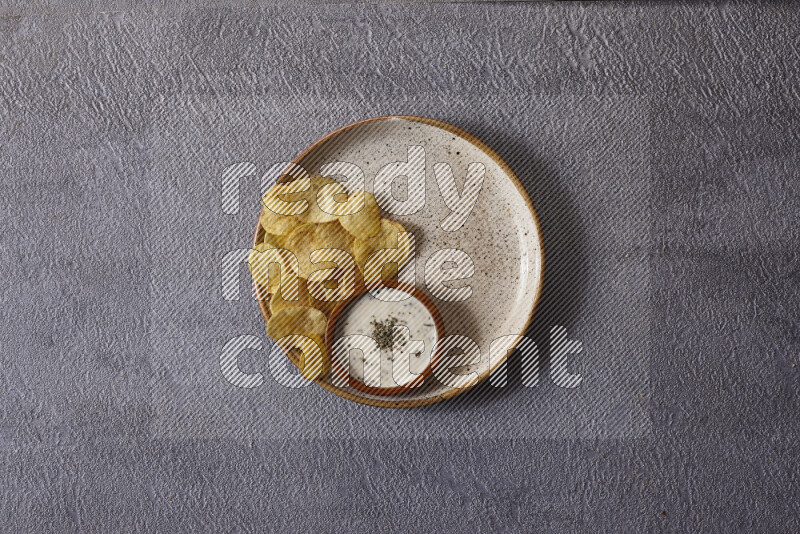 Assorted snacks in pottery bowls on grey background