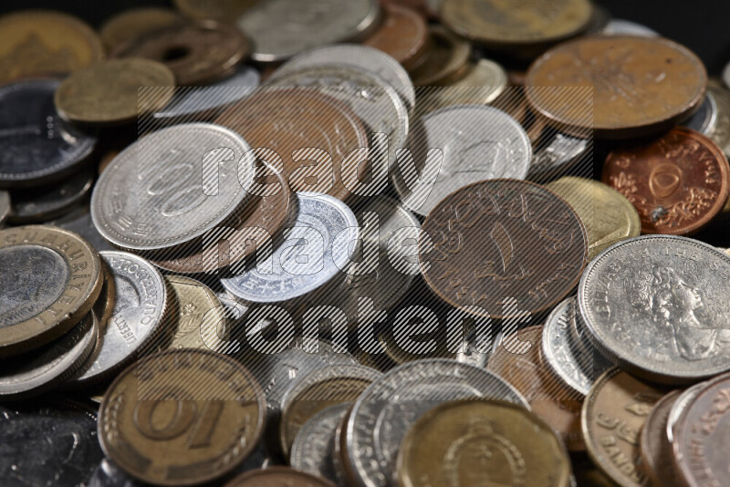 A close-ups of random old coins on black background
