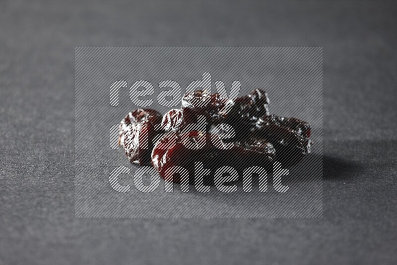 Dried plums on a black background in different angles
