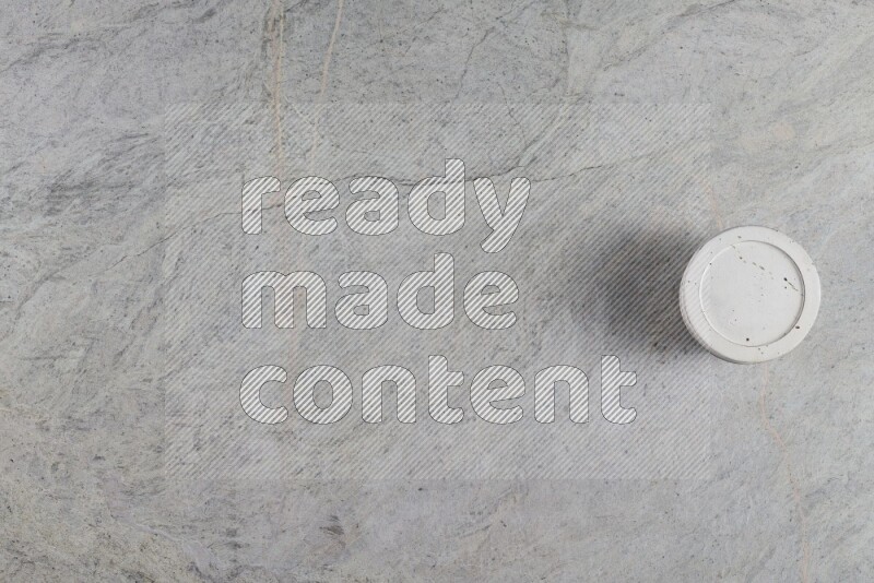 A multicolored pottery Cup on grey marble background