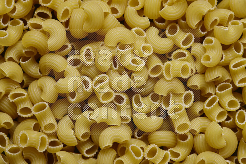 Elbow pasta on grey background