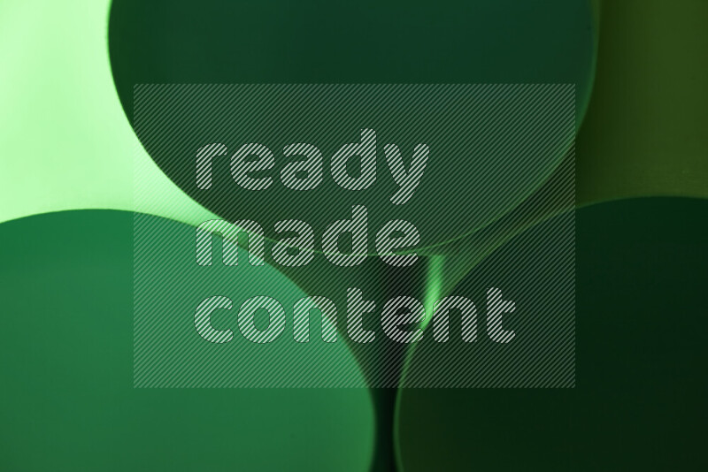 The image shows an abstract paper art with circular shapes in varying shades of green