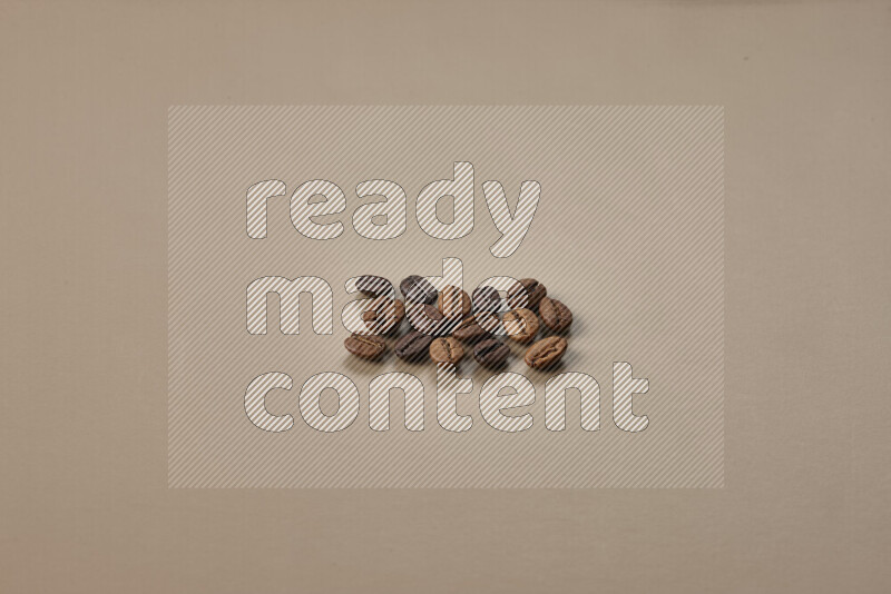 Roasted coffee beans on beige background