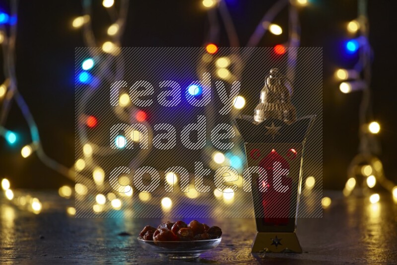 A traditional ramadan lantern surrounded by glowing fairy lights in a dark setup