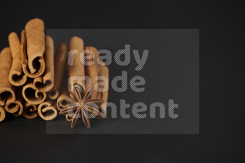 Cinnamon sticks and star anise on a black background