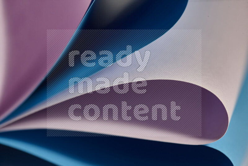 An abstract art showing purple and blue paper sheets arranged in an overlapping curves