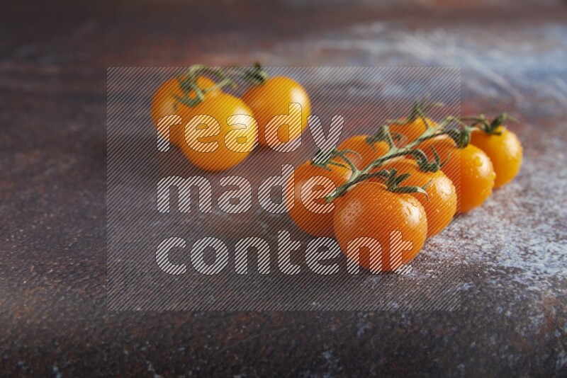 Mixed cherry tomato veins on a textured reddish rustic metal background 45 degree