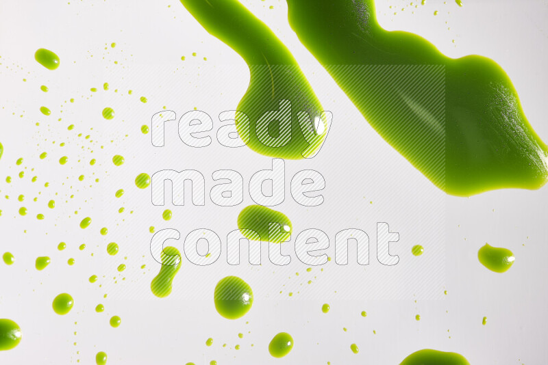 Close-ups of abstract green paint droplets on the surface