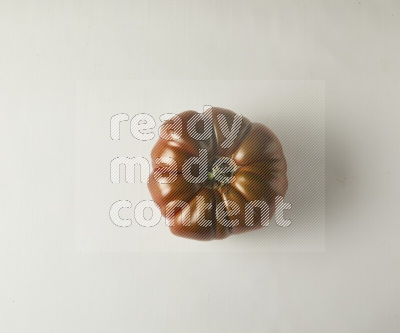 Single topview Heirloom tomato on a white backgrounds