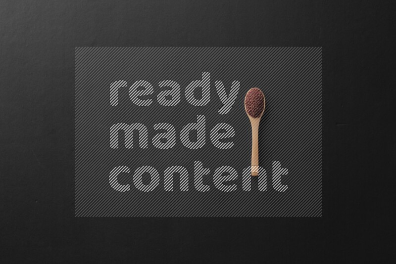 wooden spoons filled with white peppers, mustard seeds, black seeds, garden cress, cumin and flax on black flooring