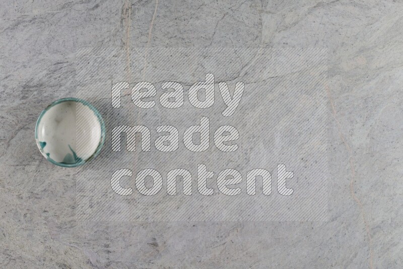 A multicolored pottery Bowl on grey marble background