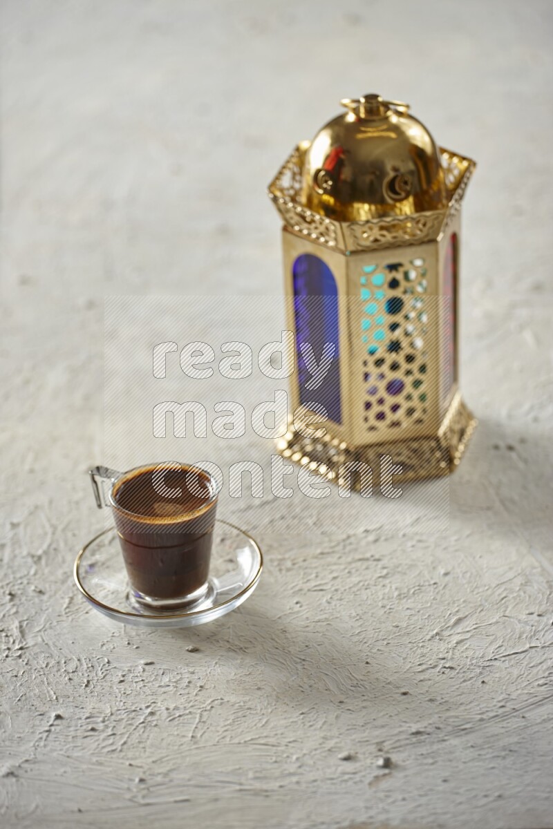 A golden lantern with different drinks, dates, nuts, prayer beads and quran on textured white background