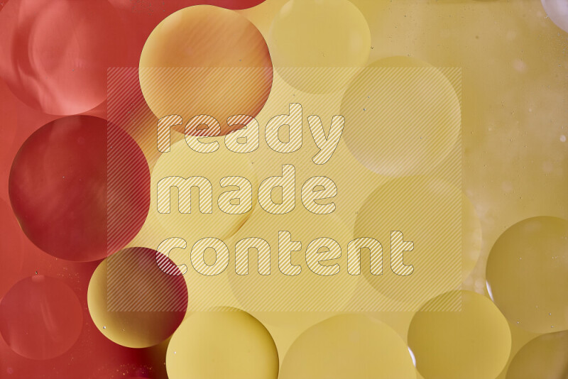 Close-ups of abstract oil bubbles on water surface in shades of red and yellow