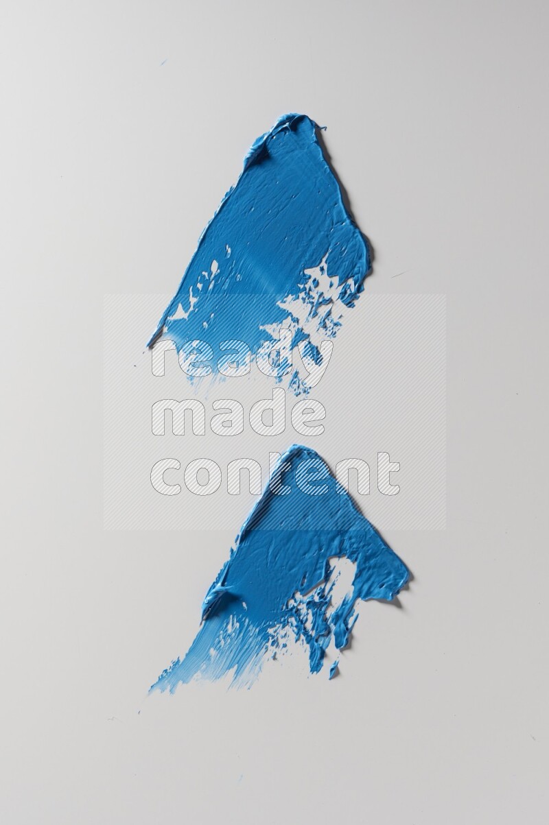 Blue painting knife strokes on white background