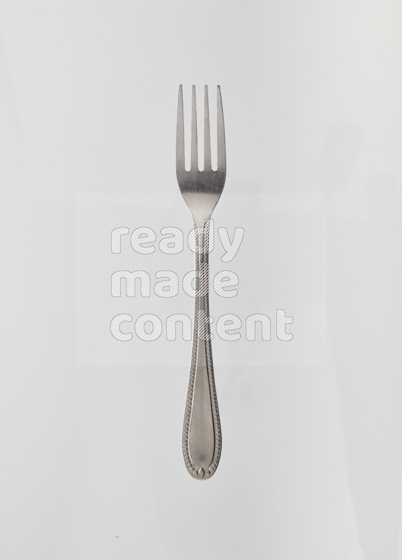 Silver stainless steel fork on white background