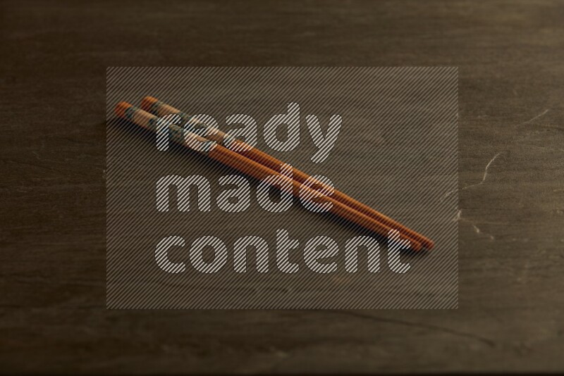wooden chopsticks on black slate background