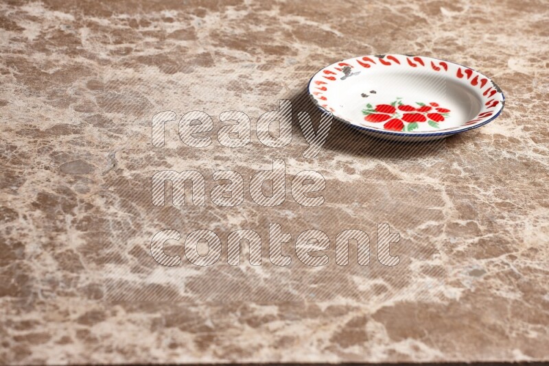 A vintage metal plate on beige marble background