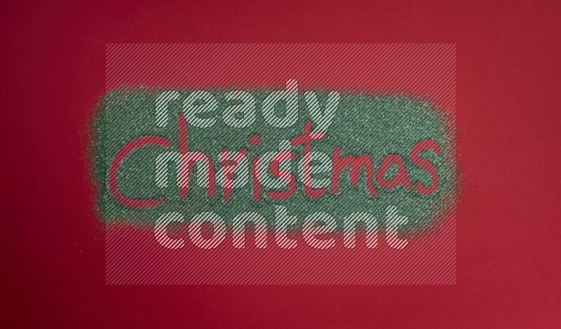 A word written with green glitter on red background