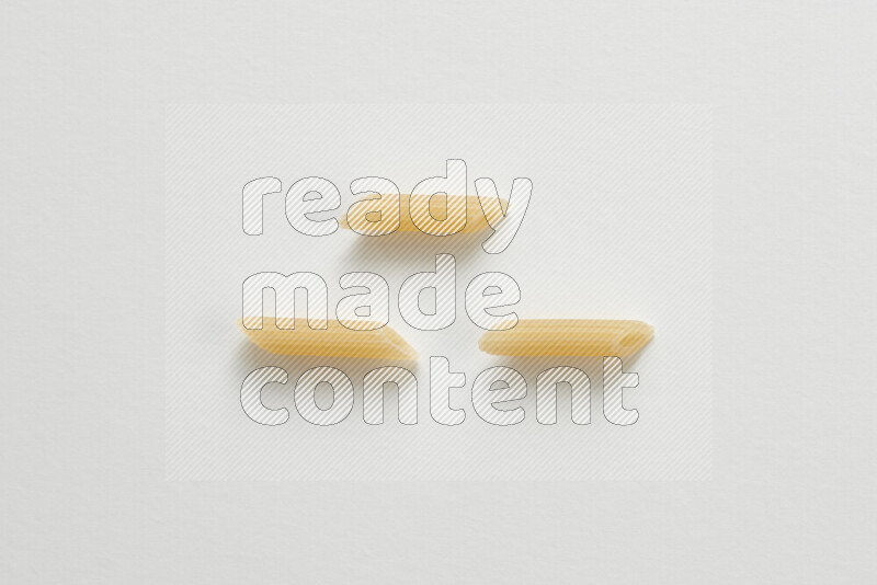 Mini penne pasta on white background