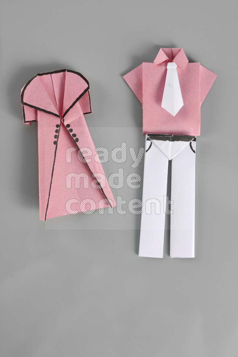 Origami clothes on grey background