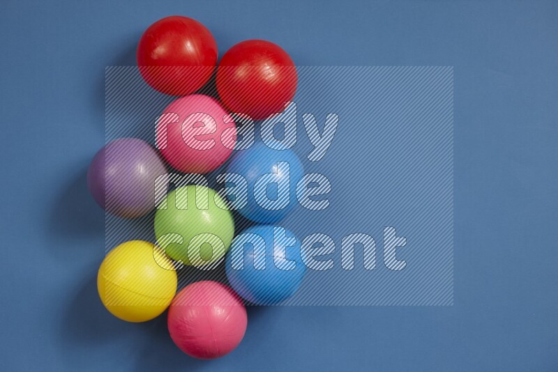 Multicolored plastic balls on different colored backgrounds (kids toys)