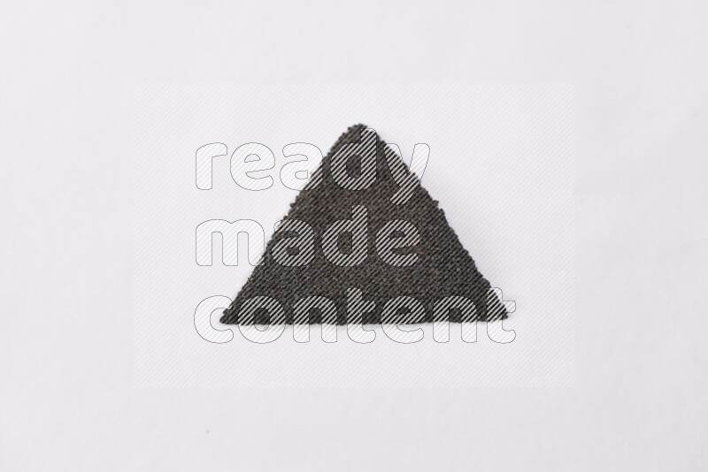 Black seeds in a triangle shape on a white flooring