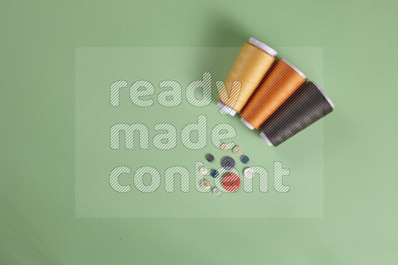 A collection of sewing and tailoring tools arranged on a green background