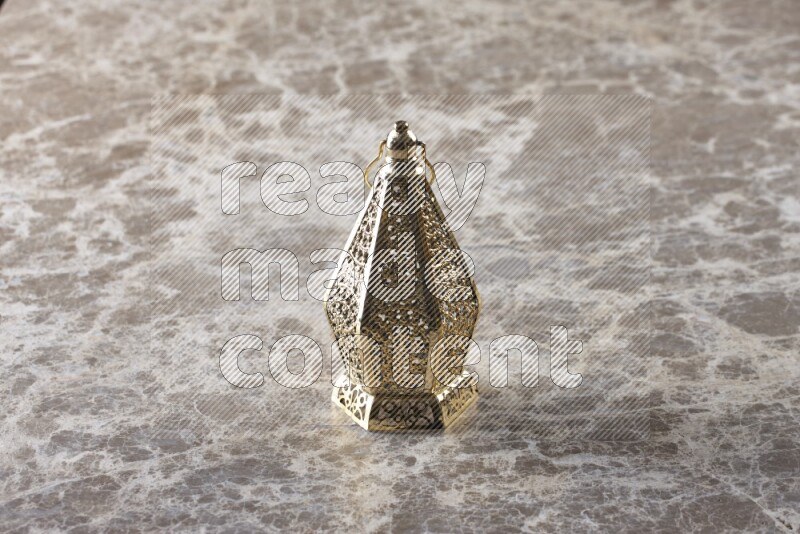 A lantern placed on a beige marble background