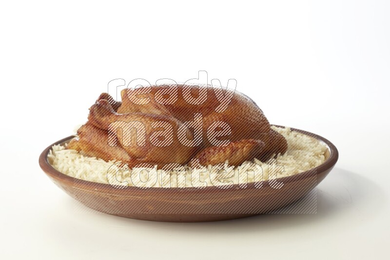 white  basmati Rice with  whole roasted chicken    on a pottery plate  direct  on white background