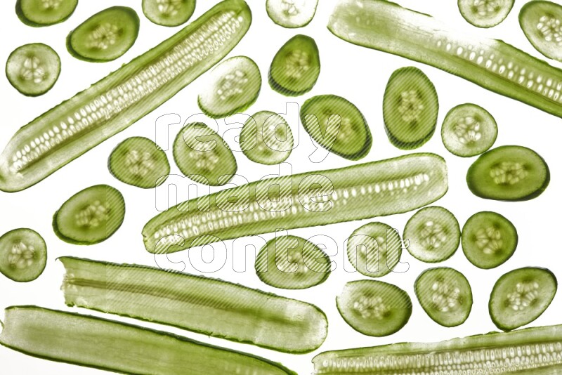 Cucumber slices on illuminated white background