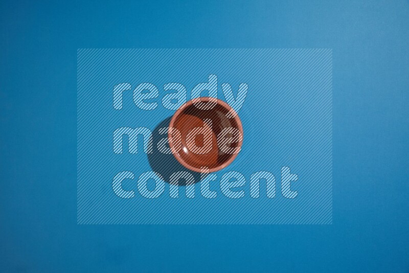 brown bowl on blue background
