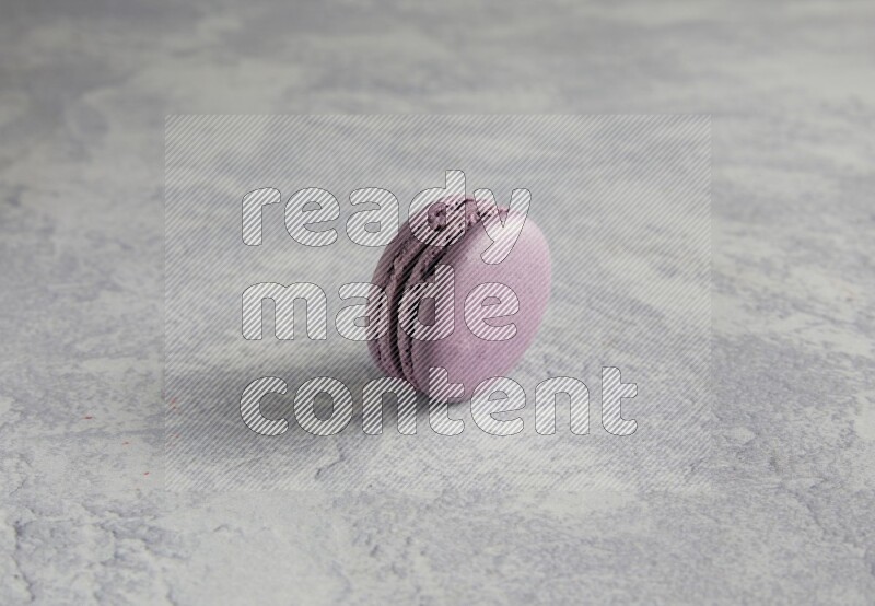45º Shot of Purple Blueberry macaron on white  marble background