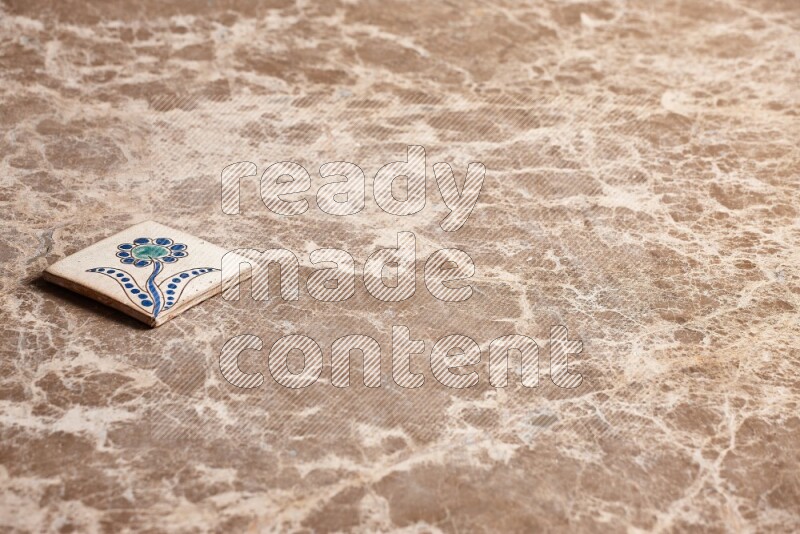 A decorative coaster on beige marble background