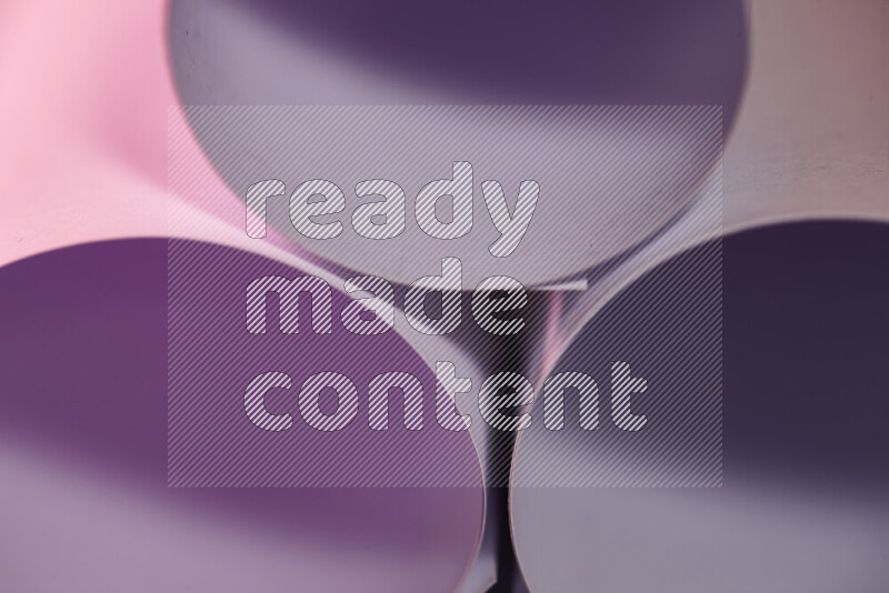 The image shows an abstract paper art with circular shapes in varying shades of purple