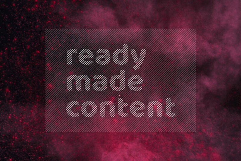 Red powder explosion on black background