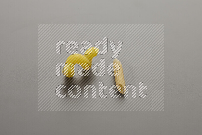 Twist pasta with other types of pasta on grey background