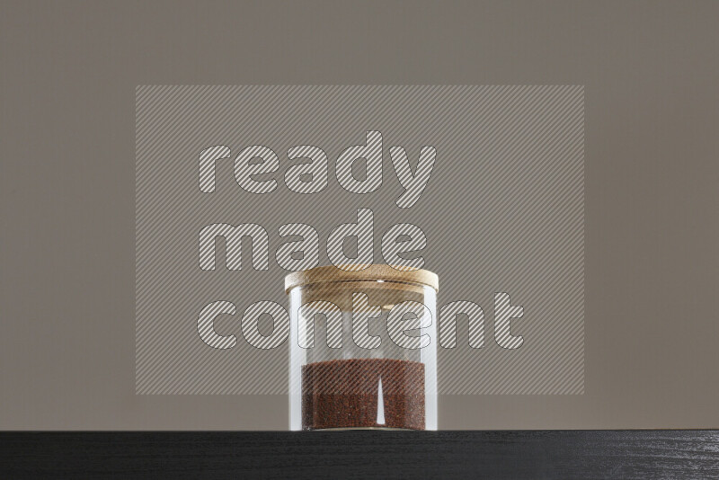 Garden cress in a glass jar on black background