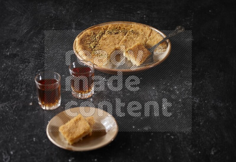 konafa with tea in a dark setup