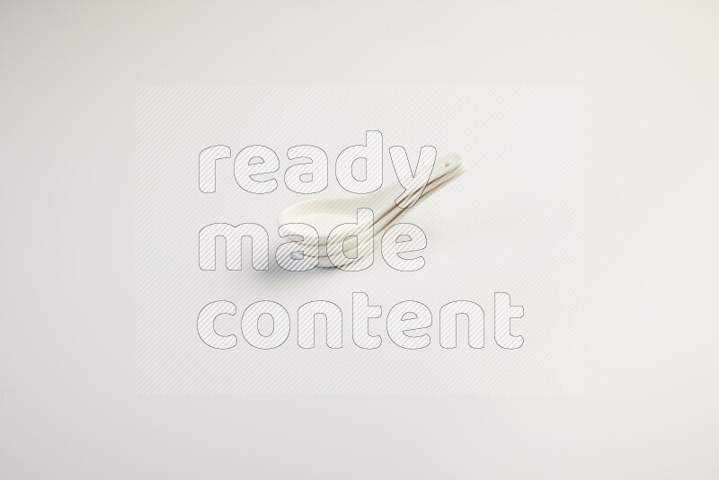 white ceramic soup spoon on white countertop