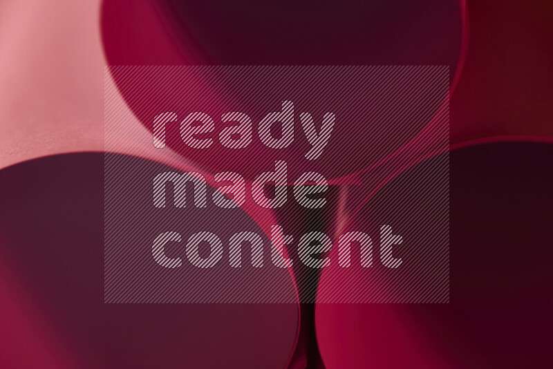 The image shows an abstract paper art with circular shapes in varying shades of red