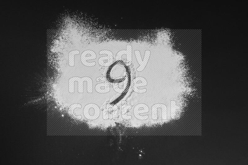 Numbers written with powder on black background