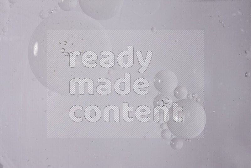 Abstract oil droplets in a water surface on white background