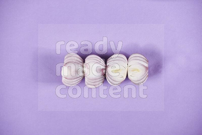 Halves red onions on a purple background