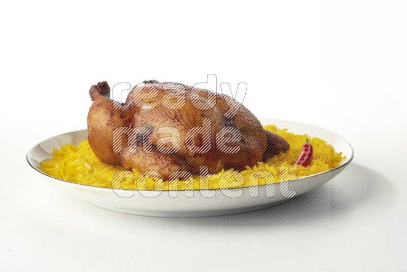 yellow  basmati Rice with kabsa chicken pieces on a white plate with a silver rim direct on white background