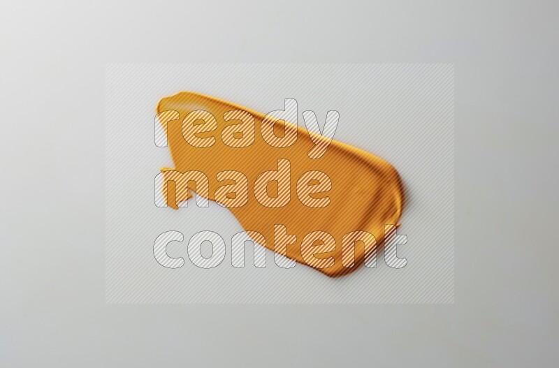 An orange straight painting knife stroke on white background