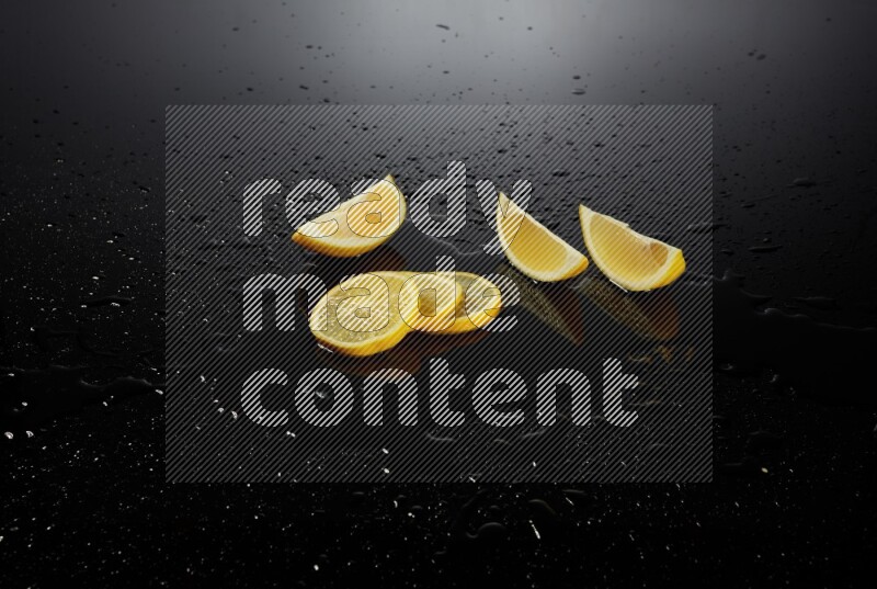Lemon slices with water drops, and droplets on black background